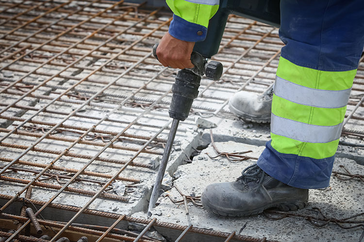 worker with jackhammer on concrete