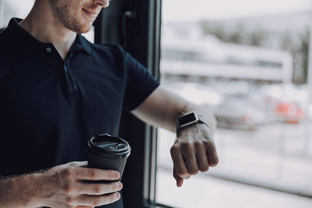 man with coffee at work in polo