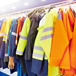 Clean High-Visibility, Reflective and Safety Workwear Hanging on Rack