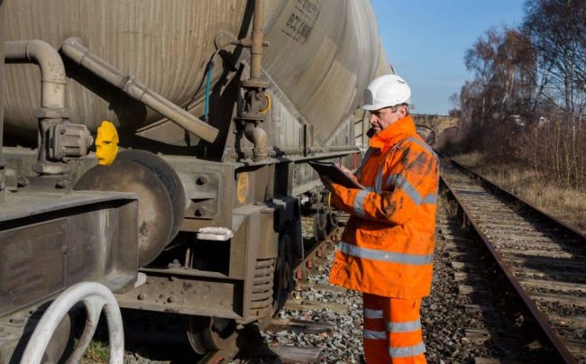 Railway inspector with dirt on workwear.