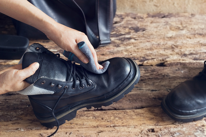 Cleaning work boots with a cloth